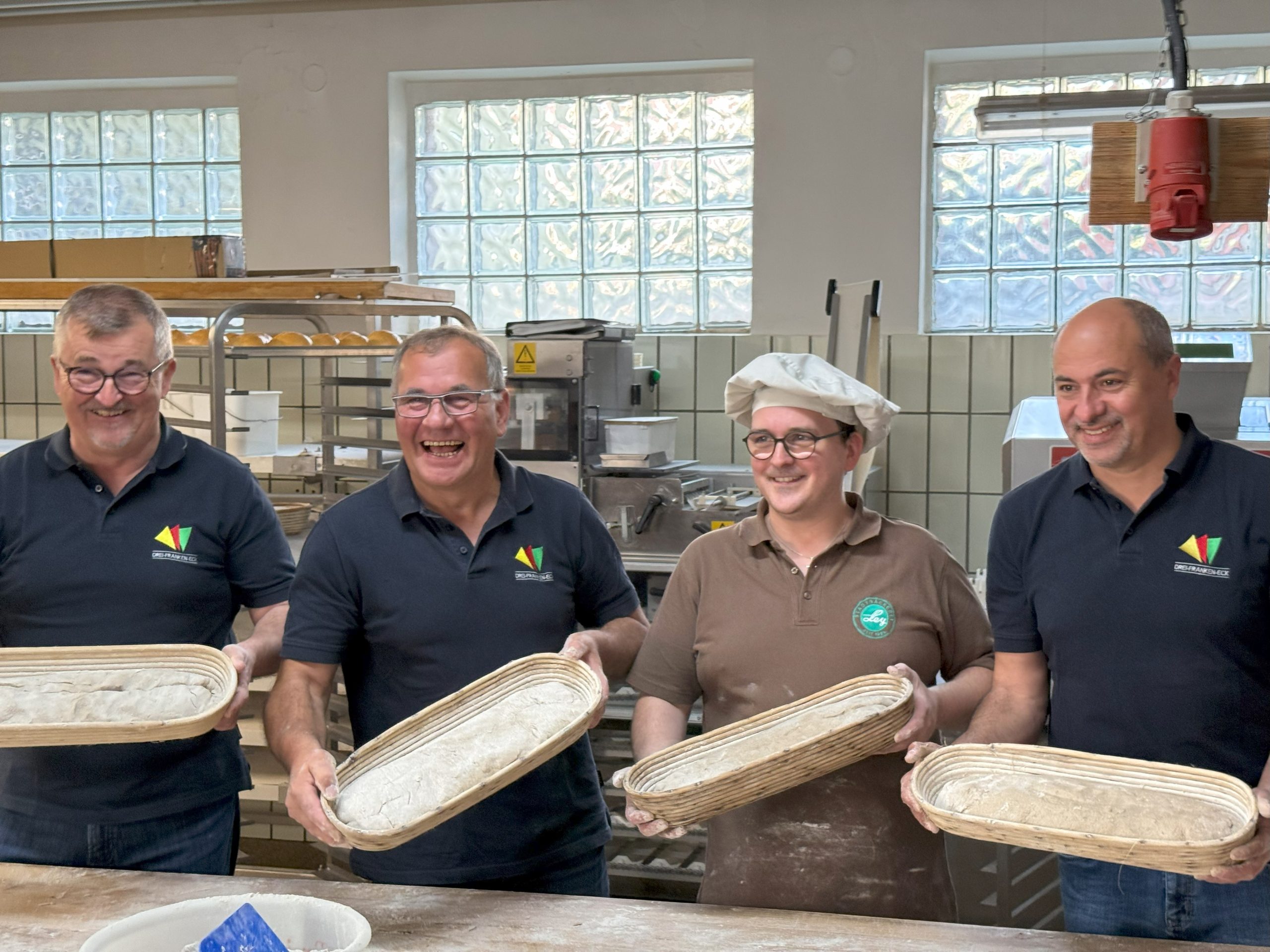 Die Drei-Franken-Bürgermeister zeigen stolz ihre fertigen Teiglinge.